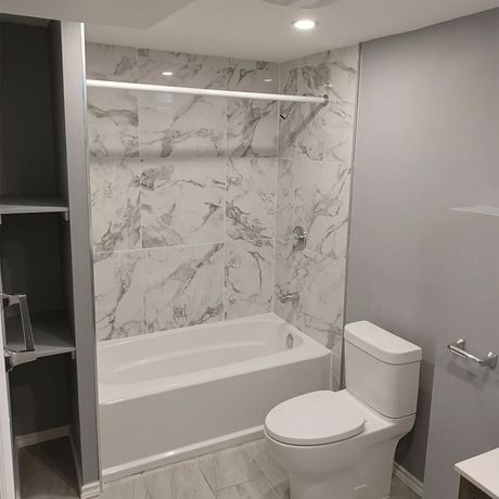 A bathroom with a toilet , sink , and bathtub. A bathroom with a toilet , sink , and bathtub.