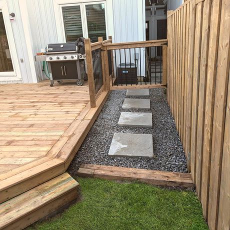 A patio with a couch , table , and potted plant. A patio with a couch , table , and potted plant.