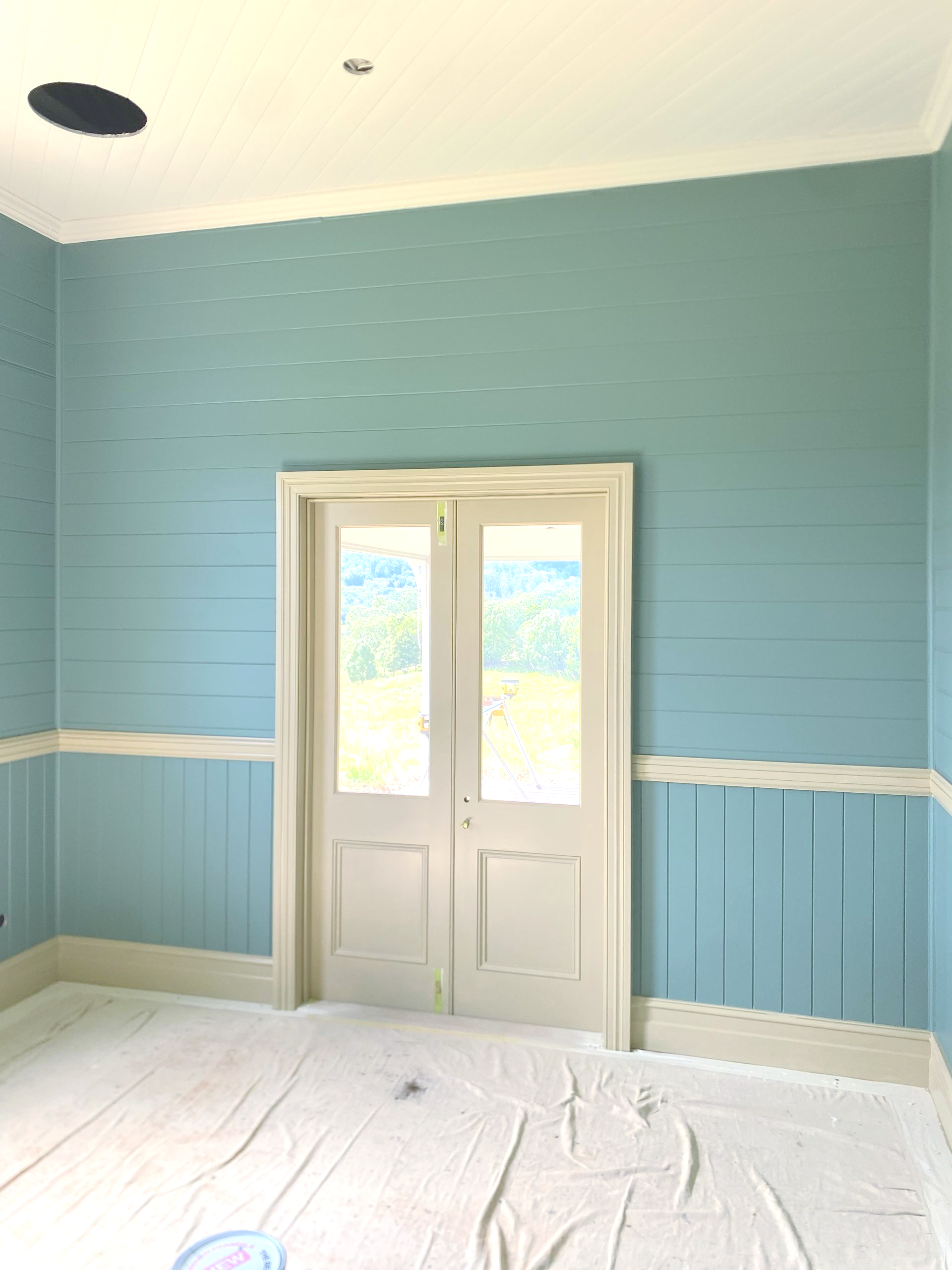 Blue wainscoted room with white double doors — C & S Building In Bentley, NSW
