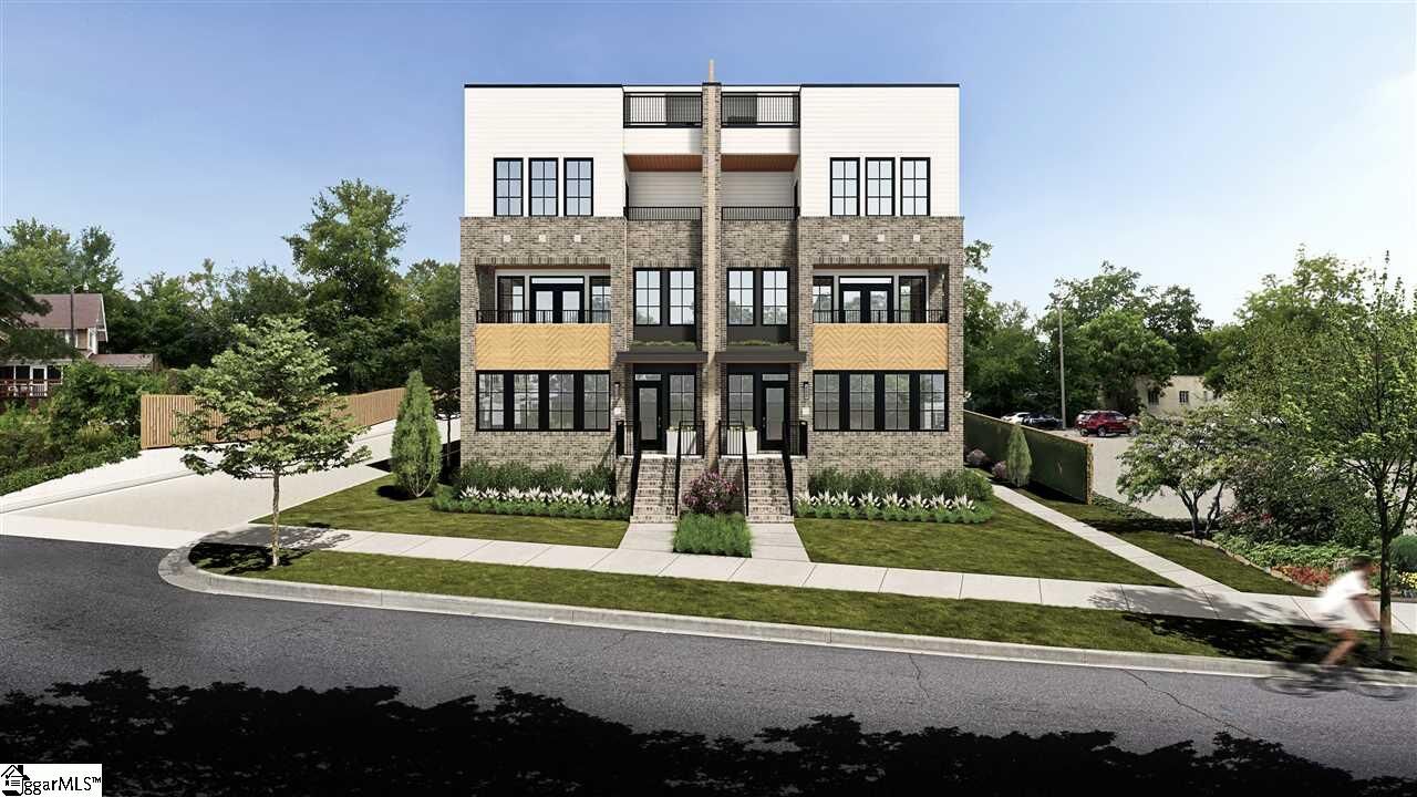 Modern three-story apartment building with stone facade, balconies, and front steps on a landscaped street corner
