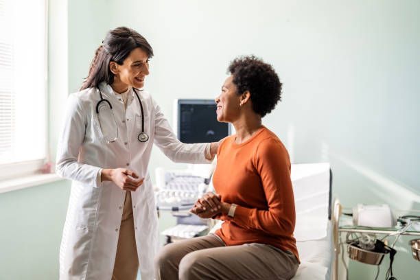 A doctor is talking to a patient in a hospital room.