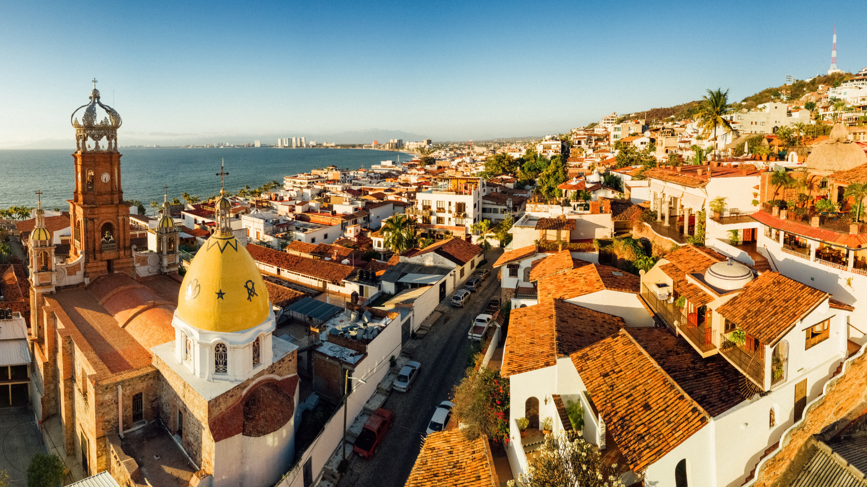 An aerial view of a small town with a church in the middle of it.