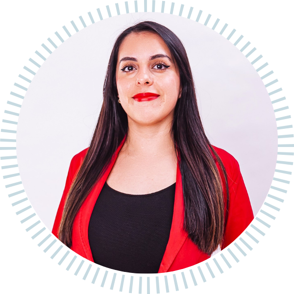 A woman in a red jacket and black shirt is standing in a circle.