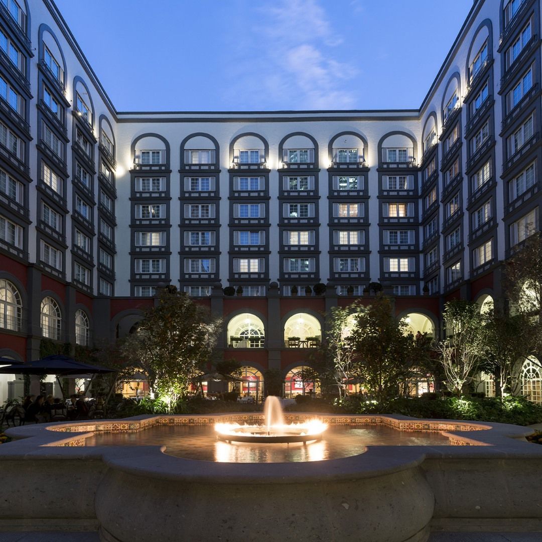 A large building with a fountain in front of it