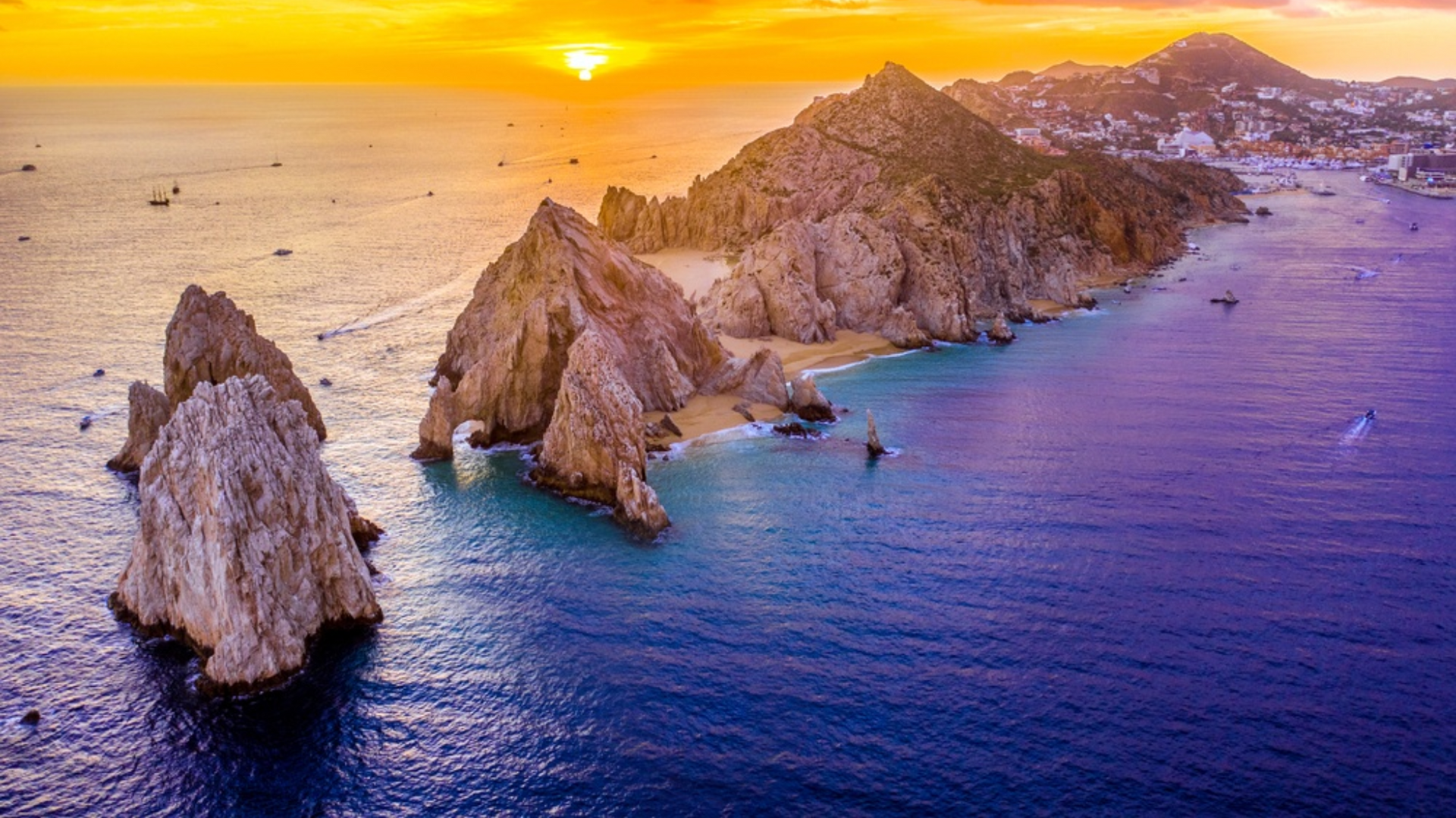 An aerial view of the cabo san lucas islands at sunset.