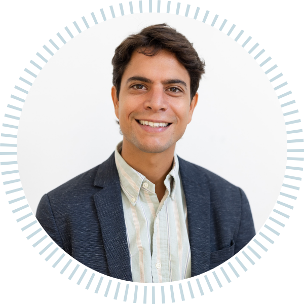 A man in a suit is smiling in a circle