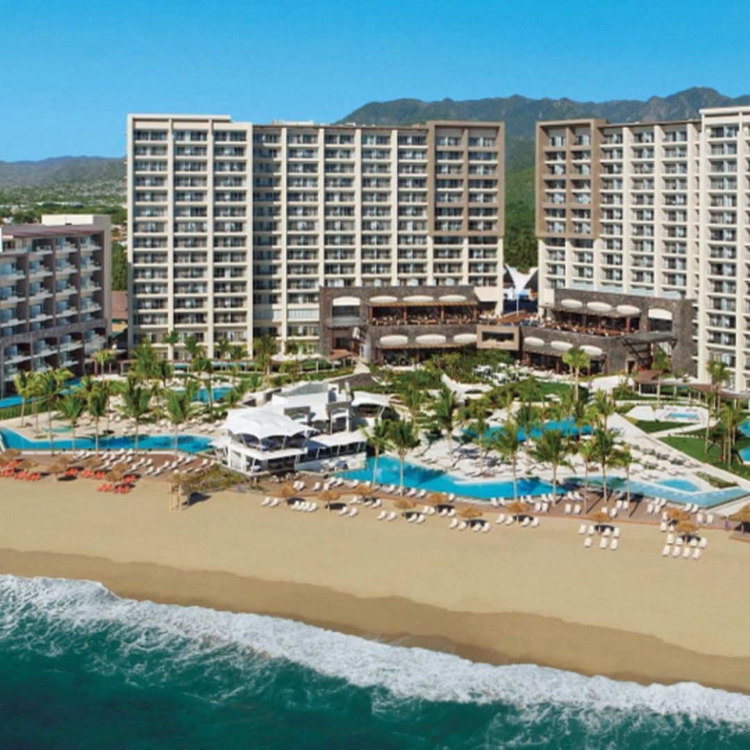 An aerial view of a beach resort with lots of buildings