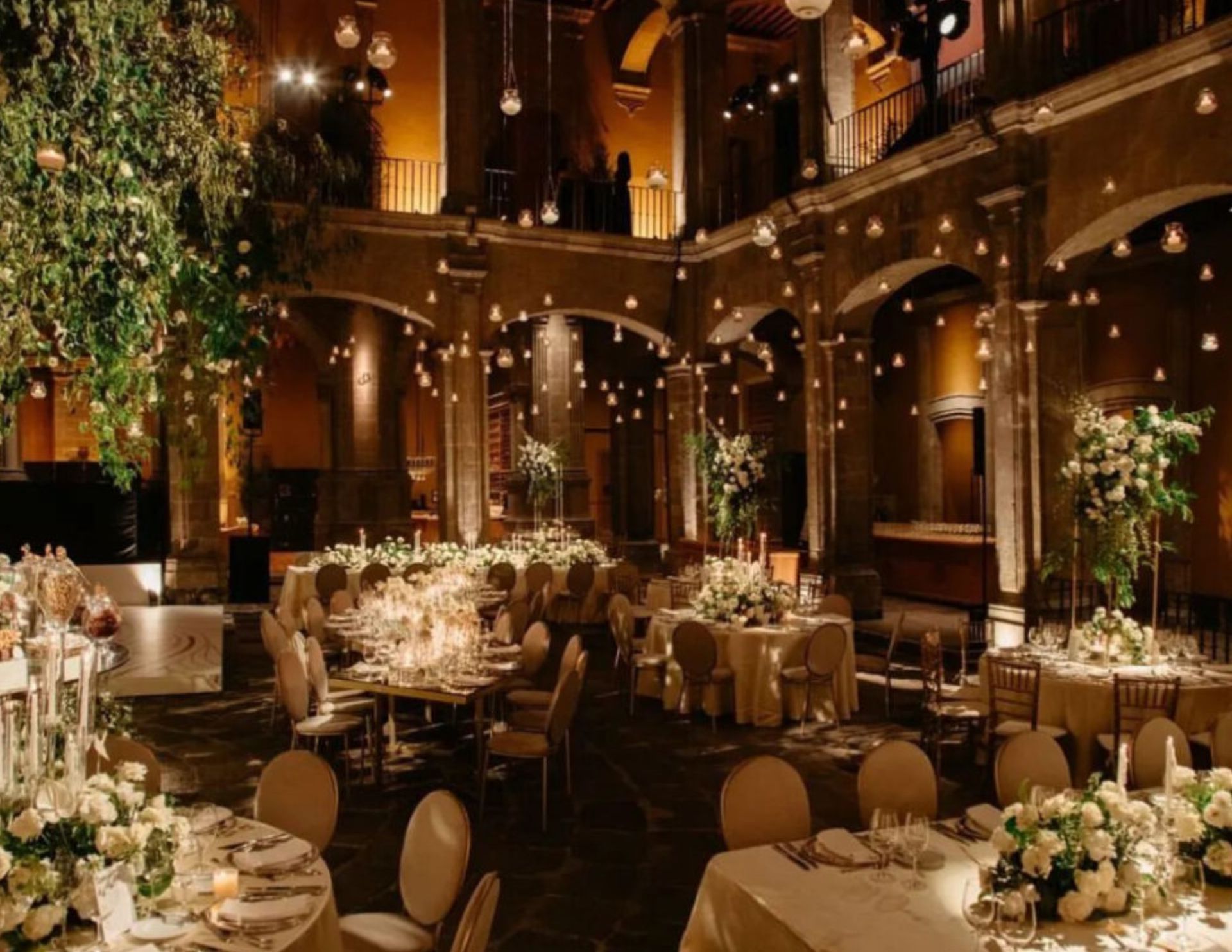 A large room with tables and chairs set up for a wedding reception.