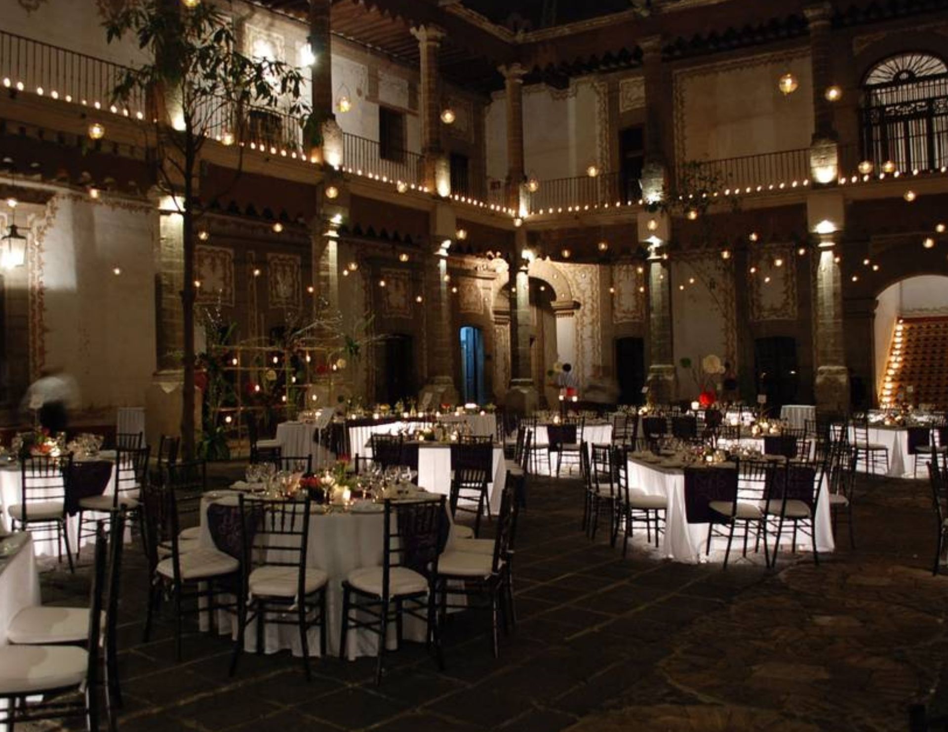 A large room with tables and chairs set up for a party