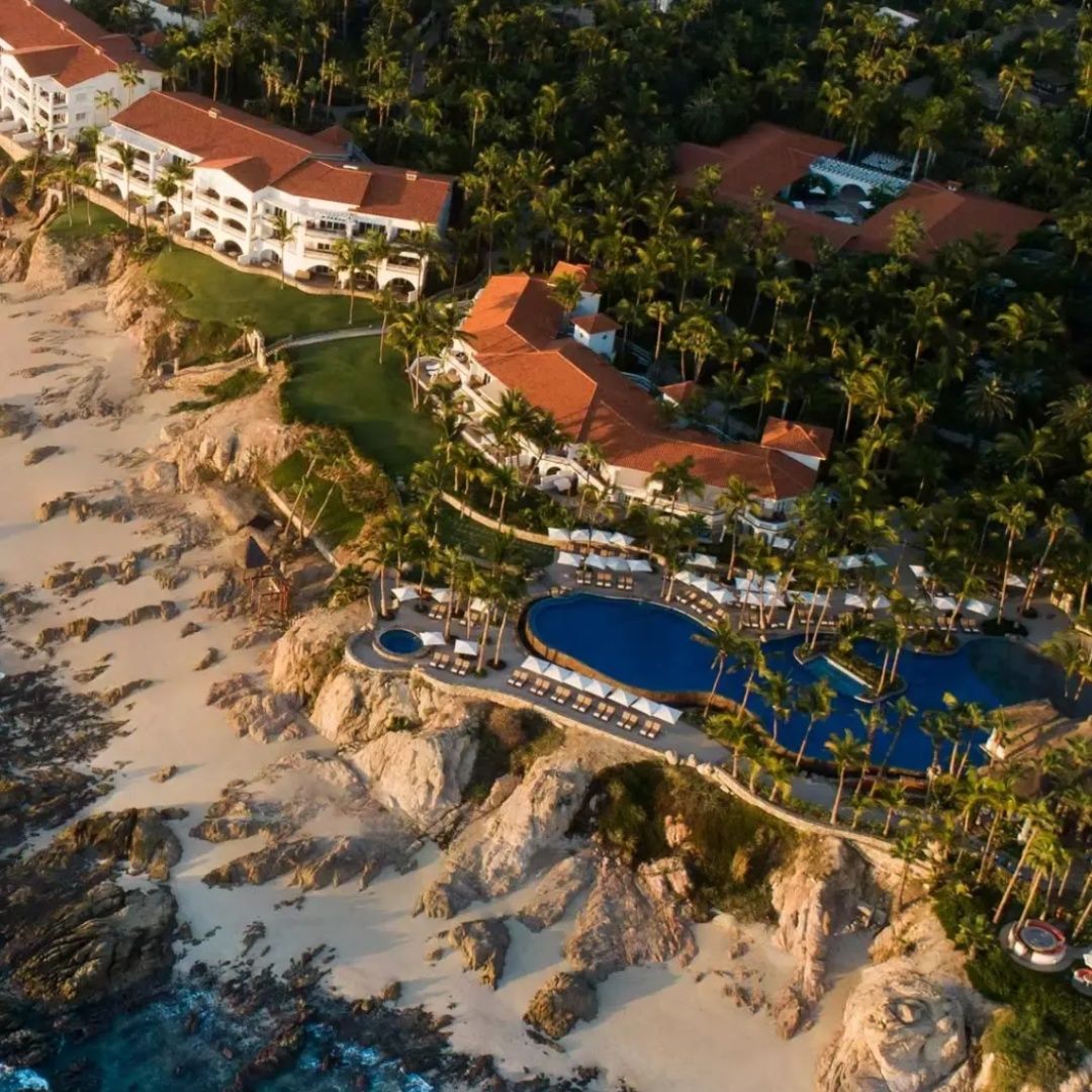 An aerial view of a resort with a large pool