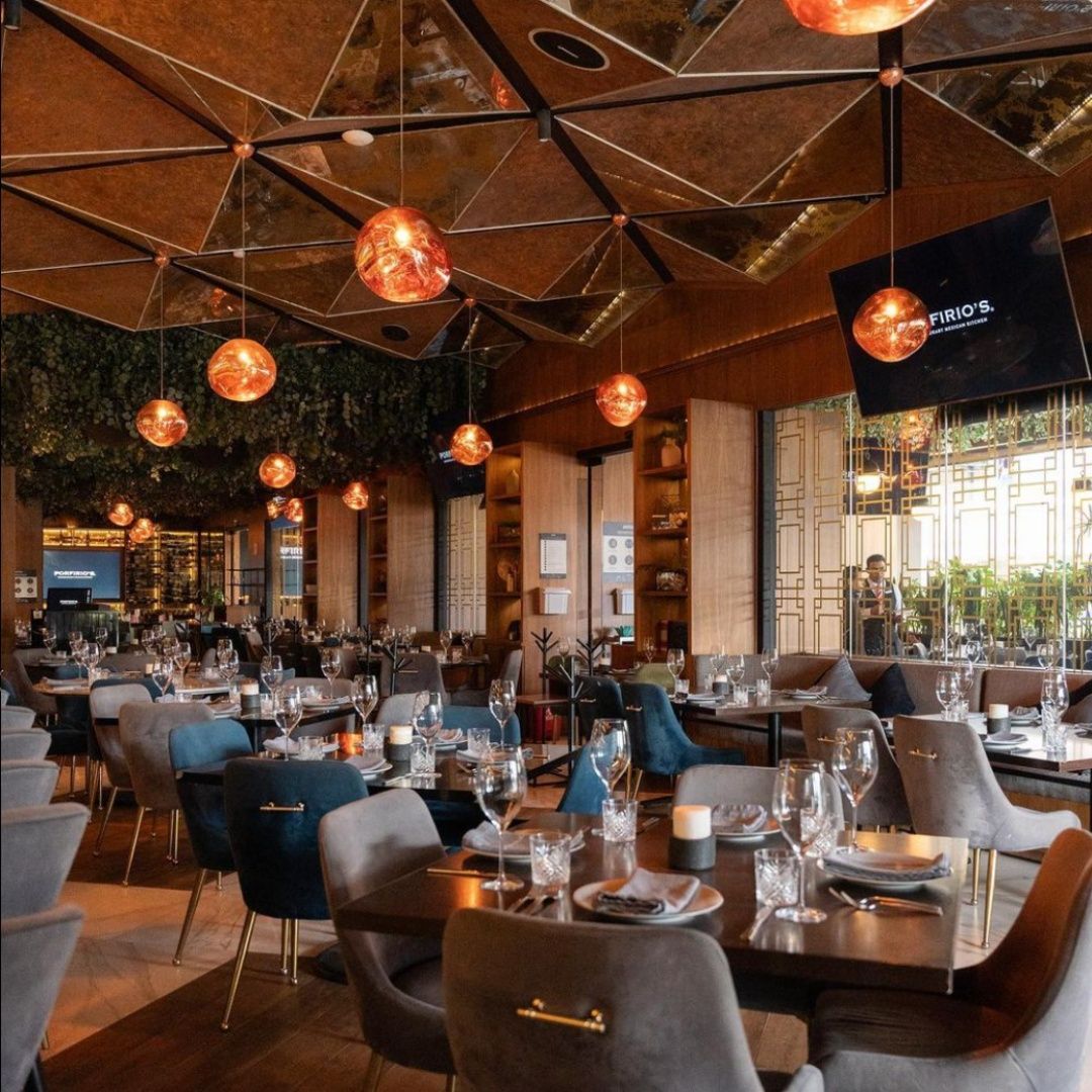 A restaurant with tables and chairs and a tv that says casa