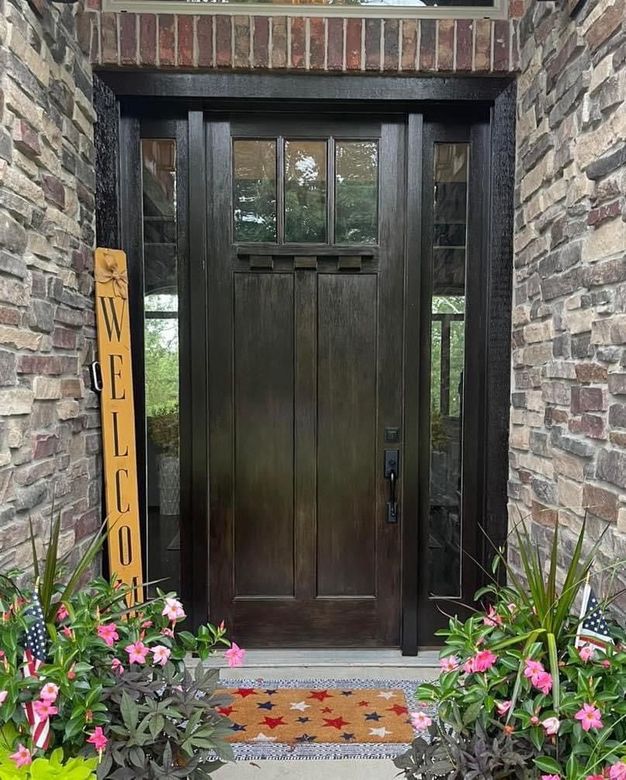 There is a welcome sign in front of the door.