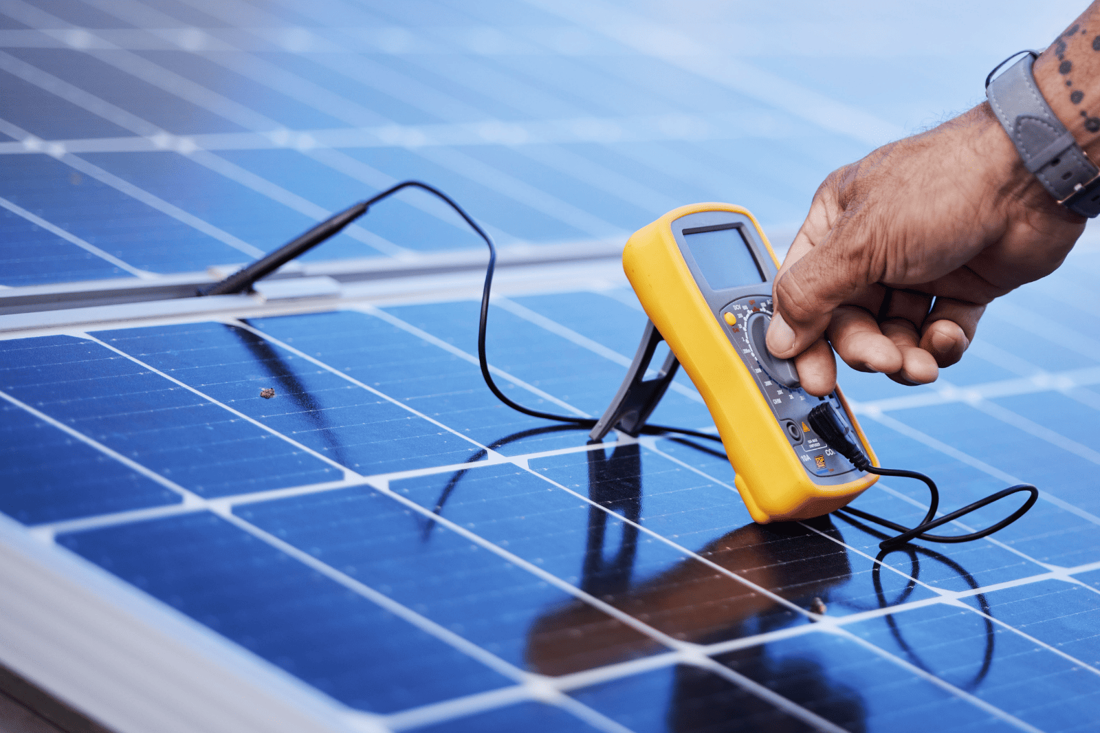 A Person is Working on a Solar Panel With a Drill and Sander — B2B Electrical and Solar In Currimundi, QLD