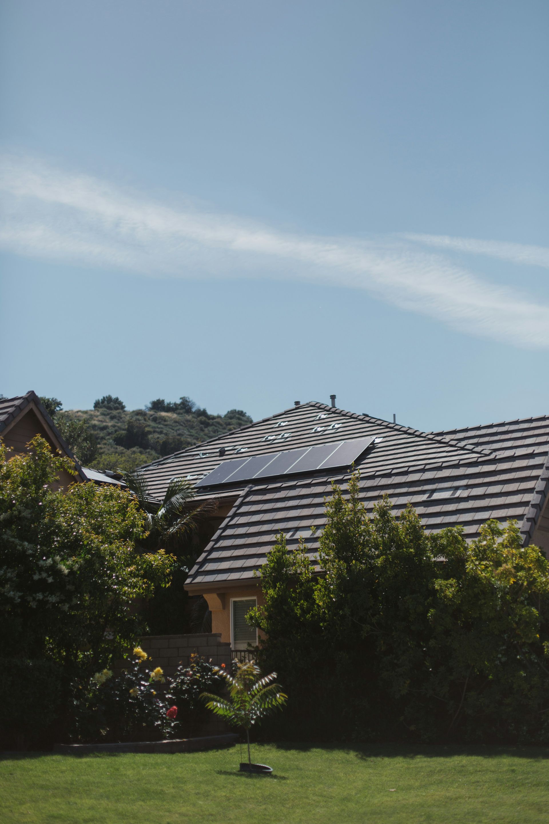 A Solar Panel is Mounted on the Side of a Building — B2B Electrical and Solar In Currimundi, QLD