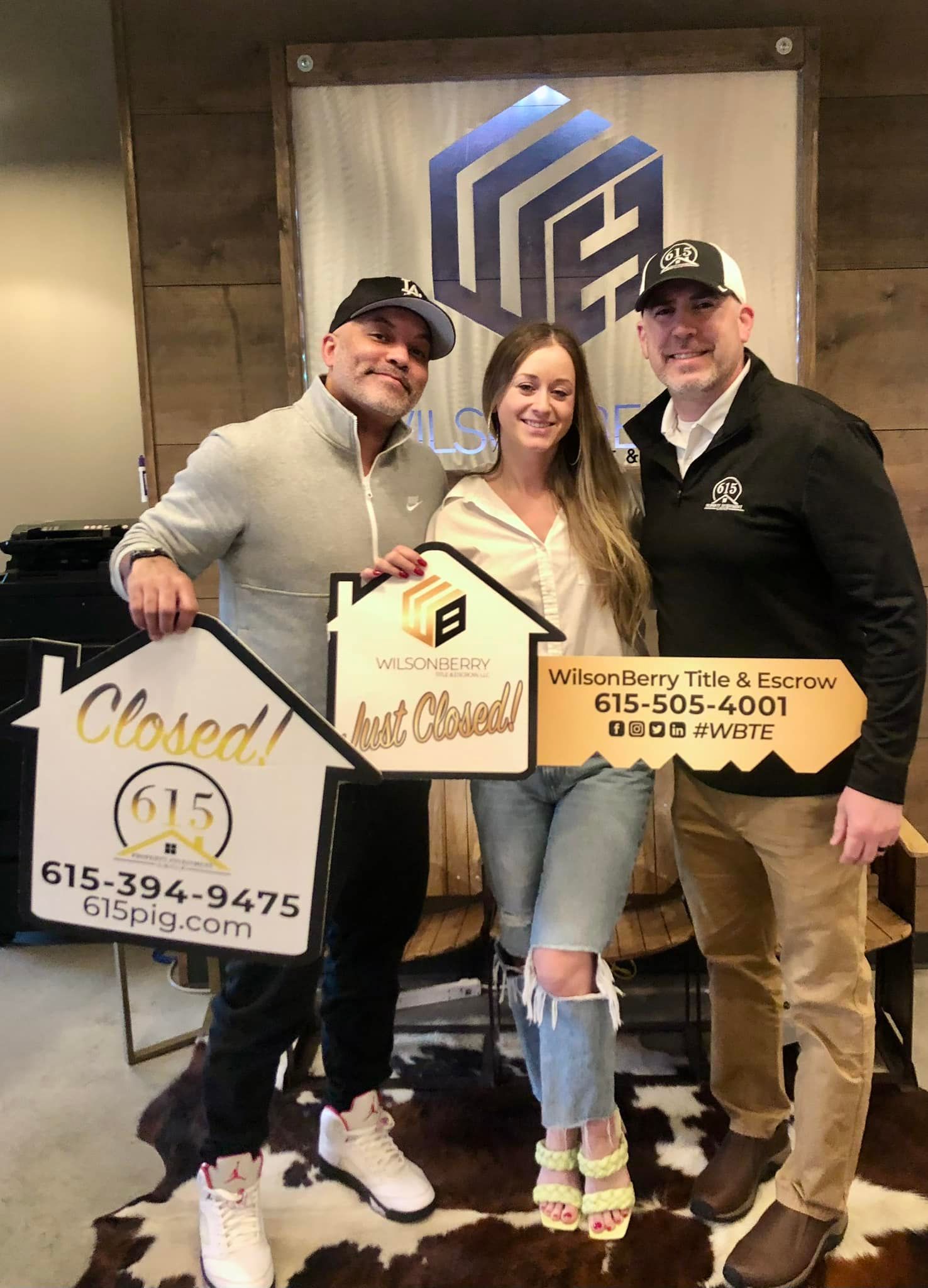Real estate agent and clients holding