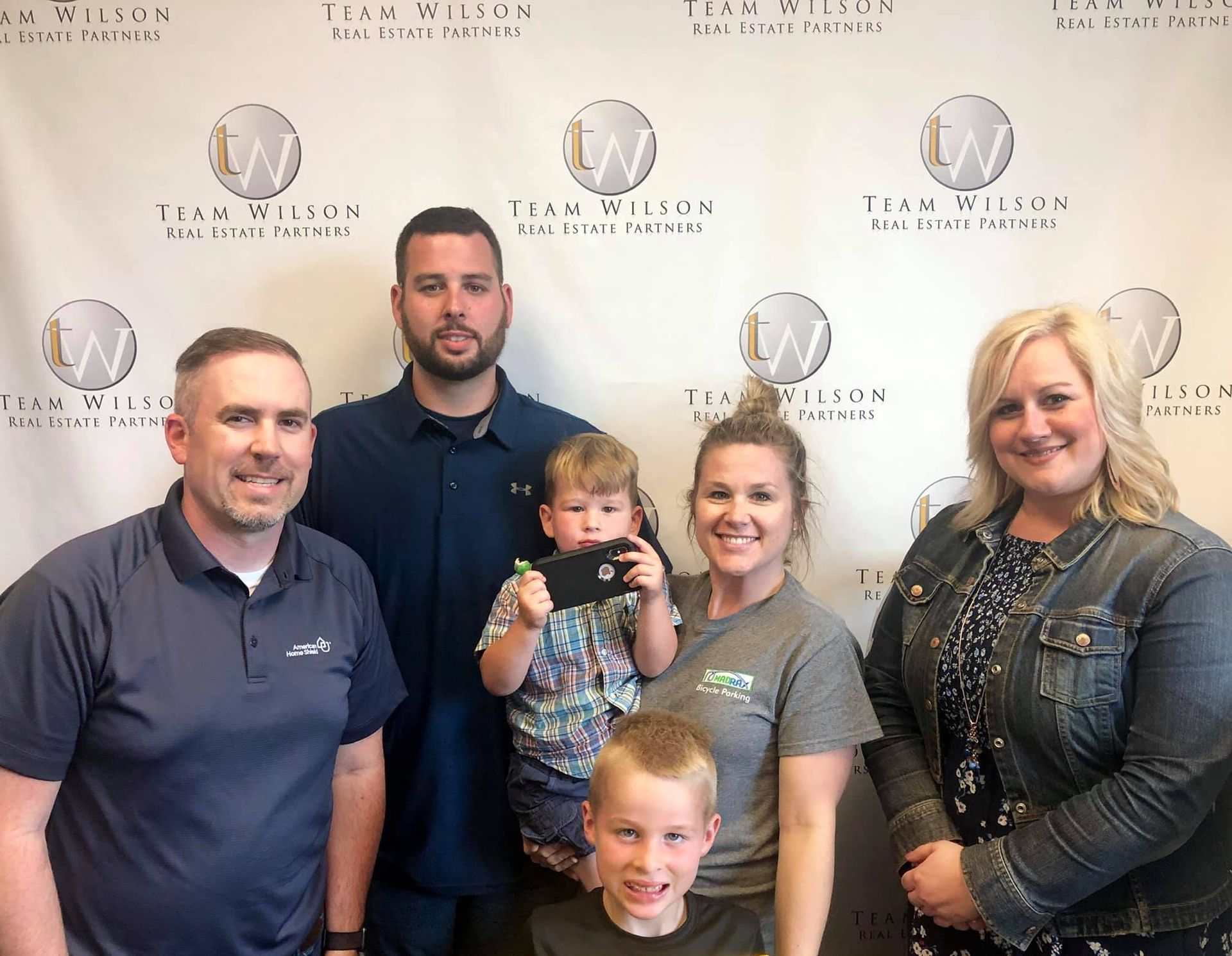 Real estate agents and clients holding