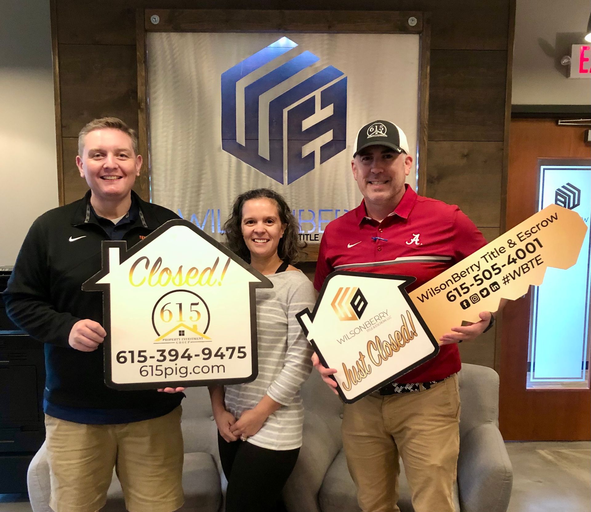 Real estate agent and clients holding