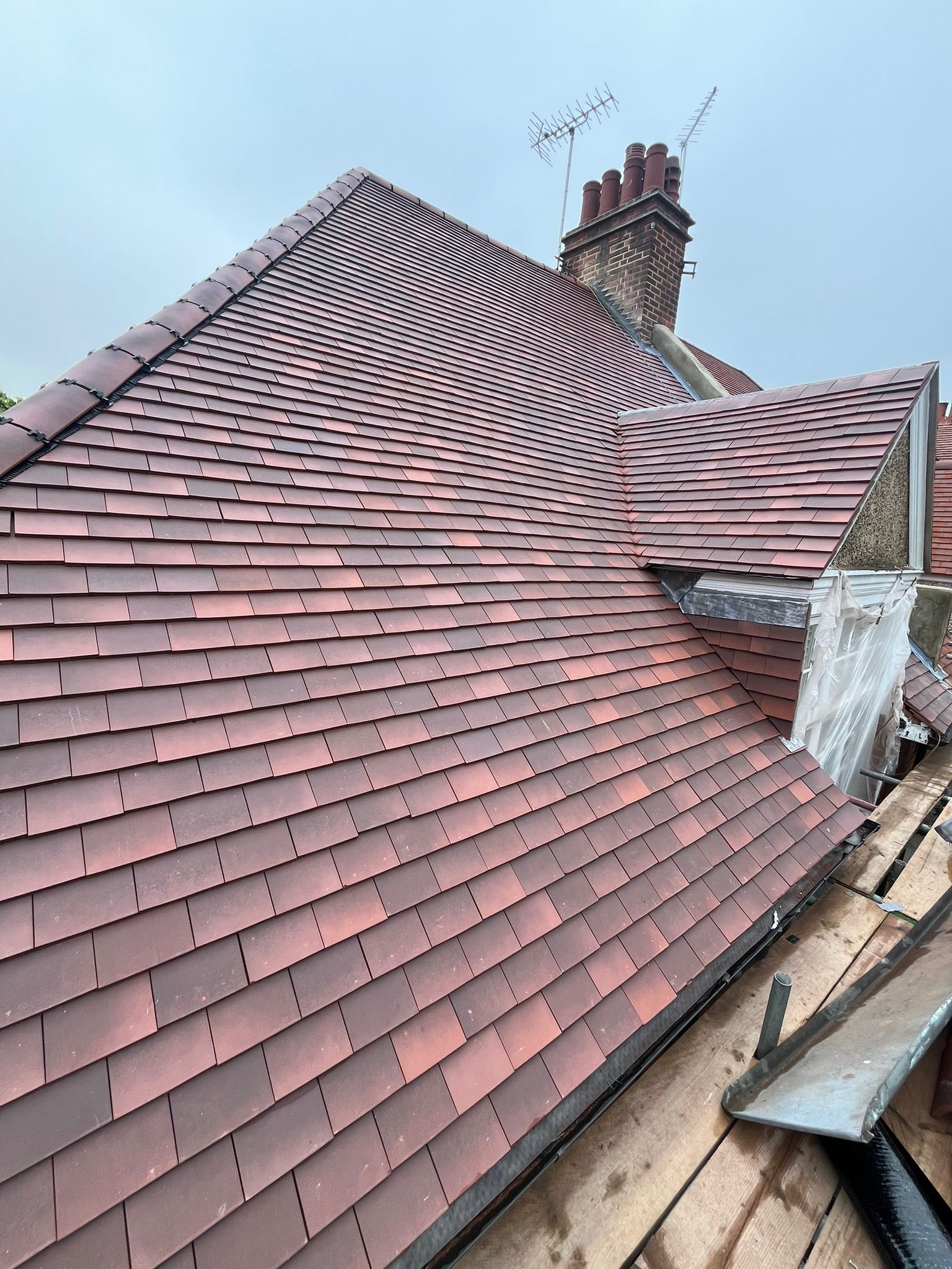A close up of a roof with a chimney on top of it.