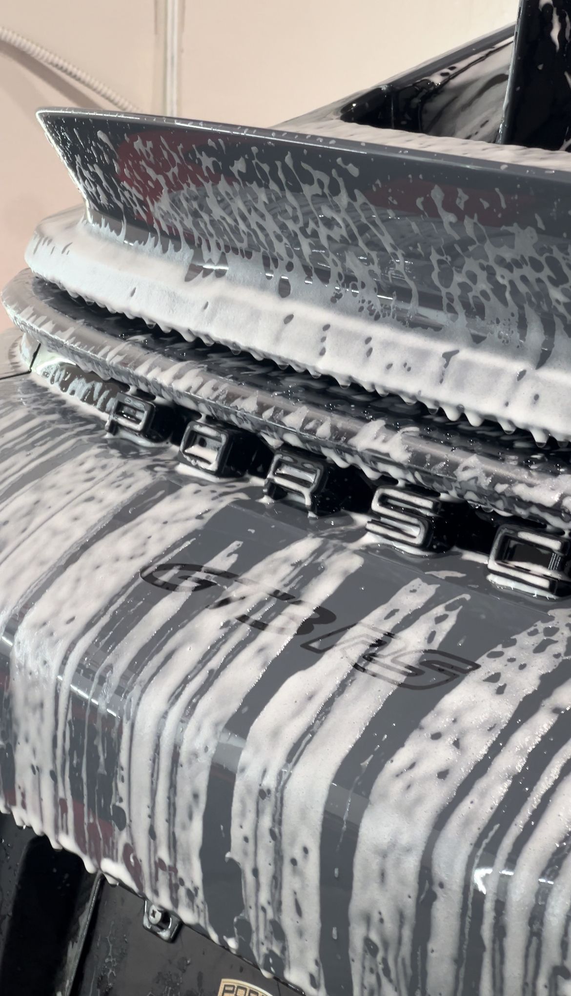 A close up of a car covered in foam.