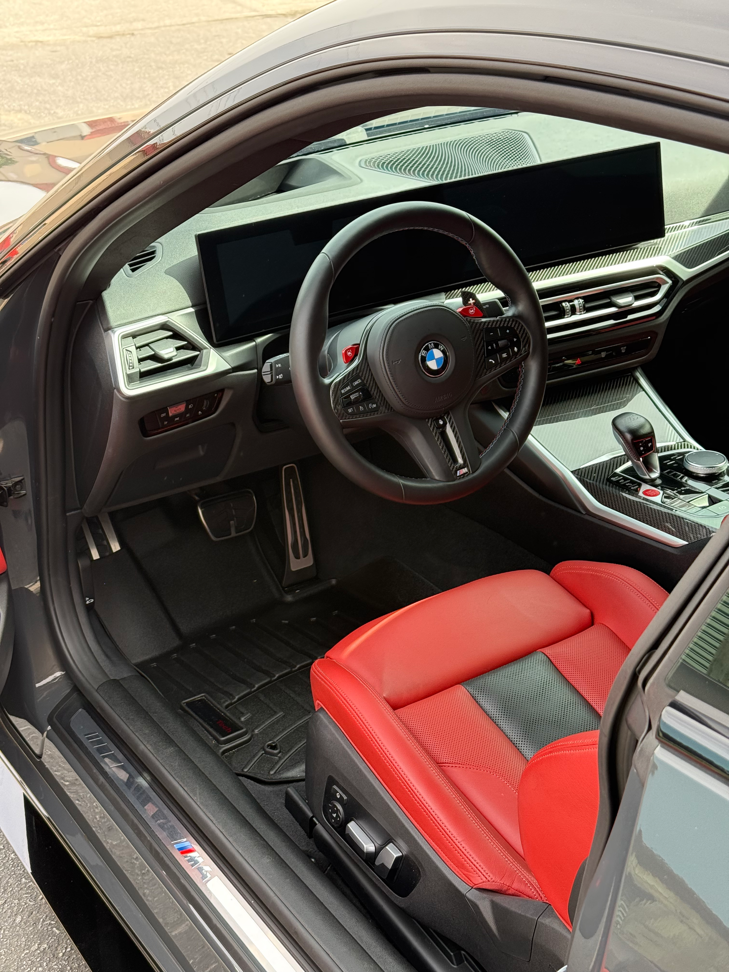 The inside of a red car with the door open