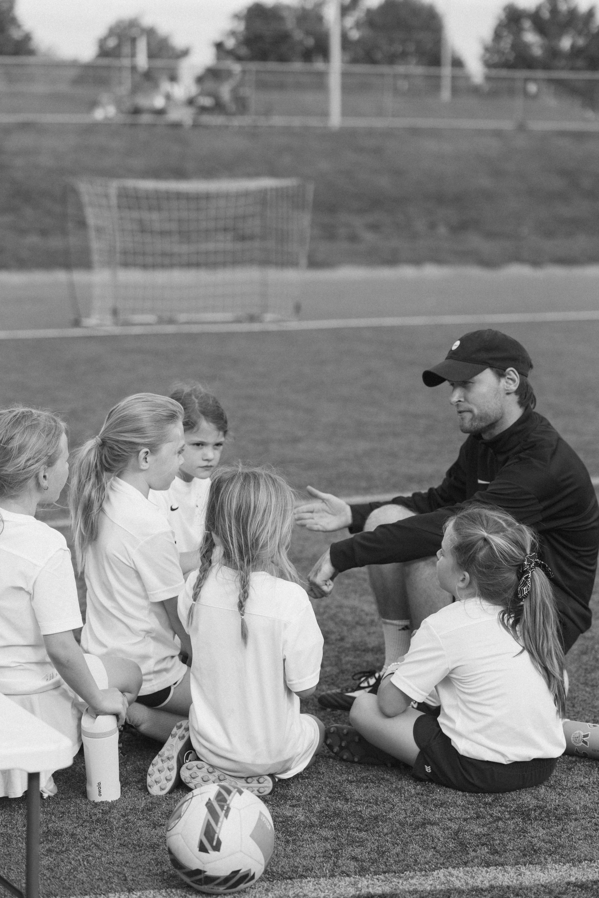 An Advantage Academy coach talking to his team on the field