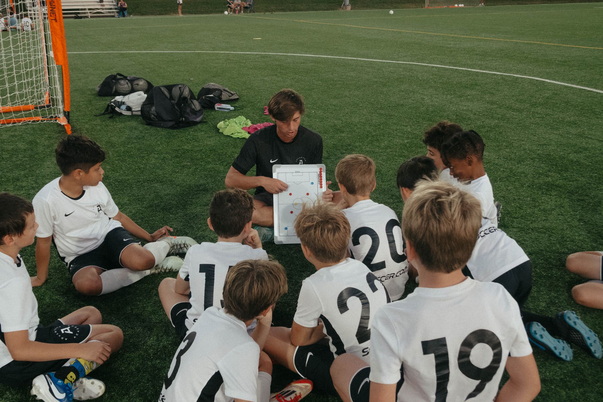 An Advantage Academy coach talking to his team on the field