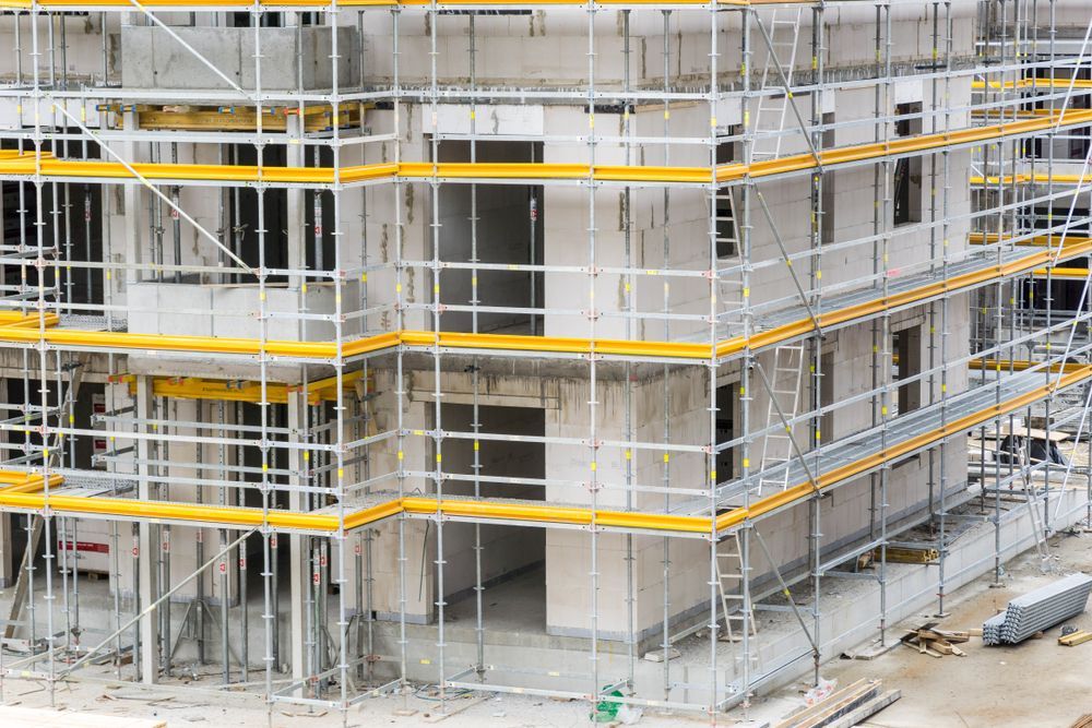 A Large Building is Being Built With Scaffolding Around It — NRS Scaffolding Pty Ltd in Yamba, NSW