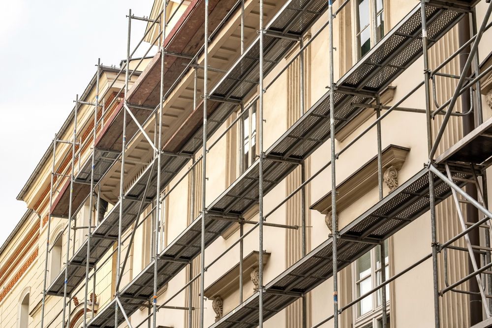 Scaffolding on Beige Building Facade for Construction or Renovation Work — NRS Scaffolding Pty Ltd in Nambucca Heads, NSW