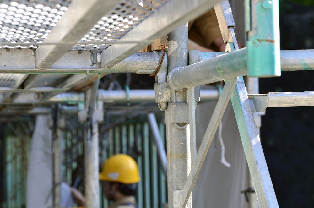 Scaffolding With a Worker in a Yellow Hard Hat; Outdoor Setting — NRS Scaffolding Pty Ltd in Harrington, NSW