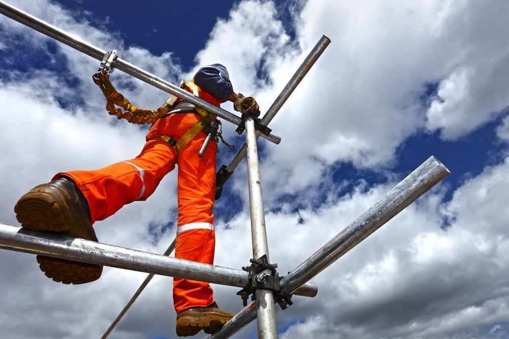A Man in Orange Pants is Standing on a Scaffolding — NRS Scaffolding Pty Ltd in Clifden, NSW