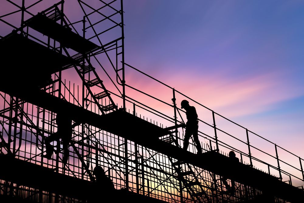 A Silhouette of a Man Standing on a Scaffolding at Sunset — NRS Scaffolding Pty Ltd in Clarence Valley, NSW