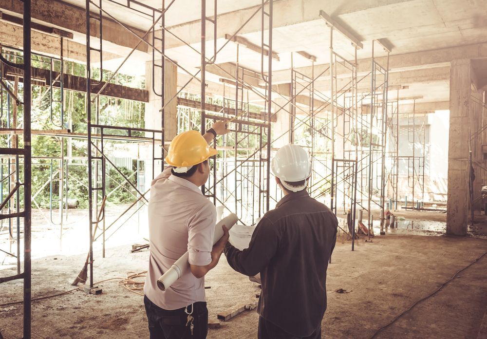 Two Construction Workers With Blueprints Inspecting Scaffolding — NRS Scaffolding Pty Ltd in Laurieton, NSW