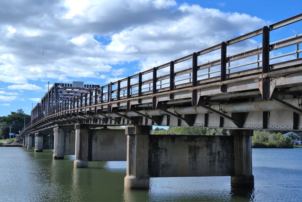 A Bridge Over a Body of Water on a Cloudy Day — NRS Scaffolding Pty Ltd in Macksville, NSW