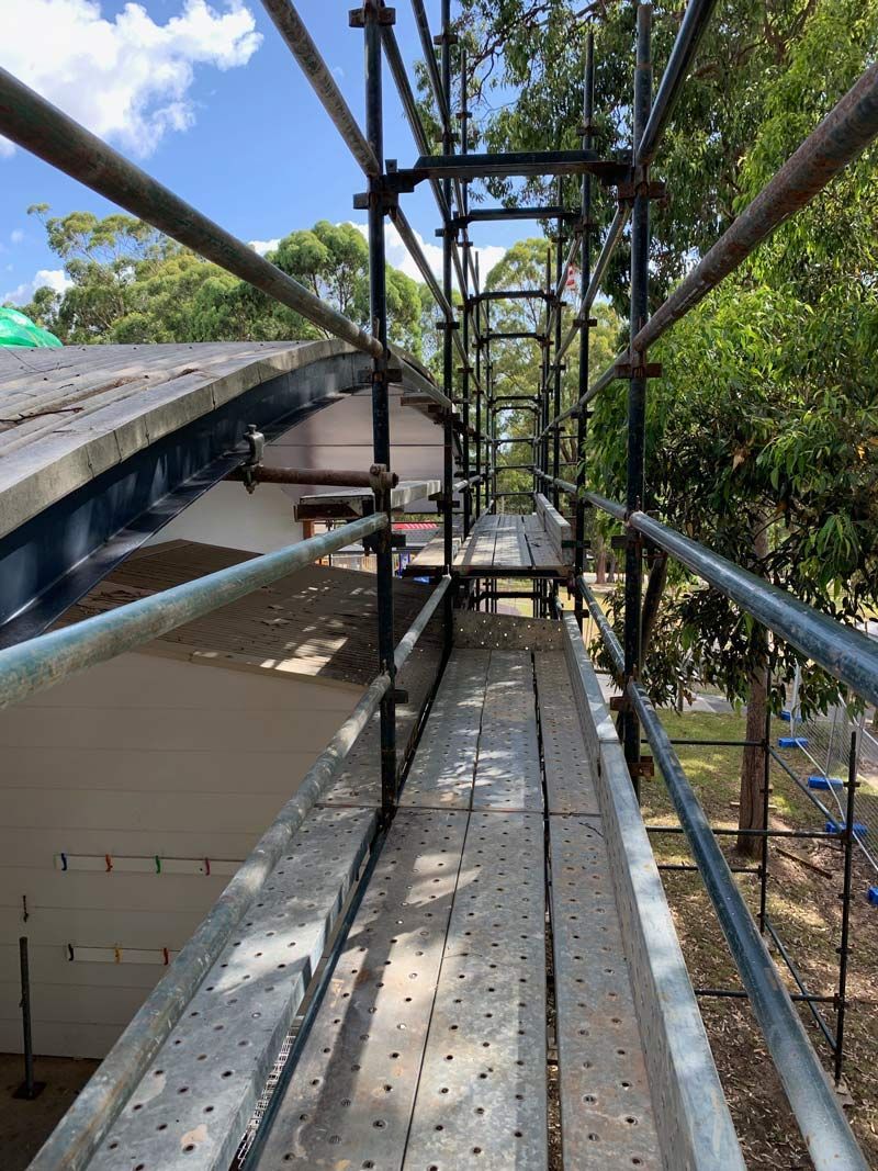 Scaffolding Platform Along a Building's Roof, With Safety Rails and a Metal Deck — NRS Scaffolding Pty Ltd in Laurieton, NSW