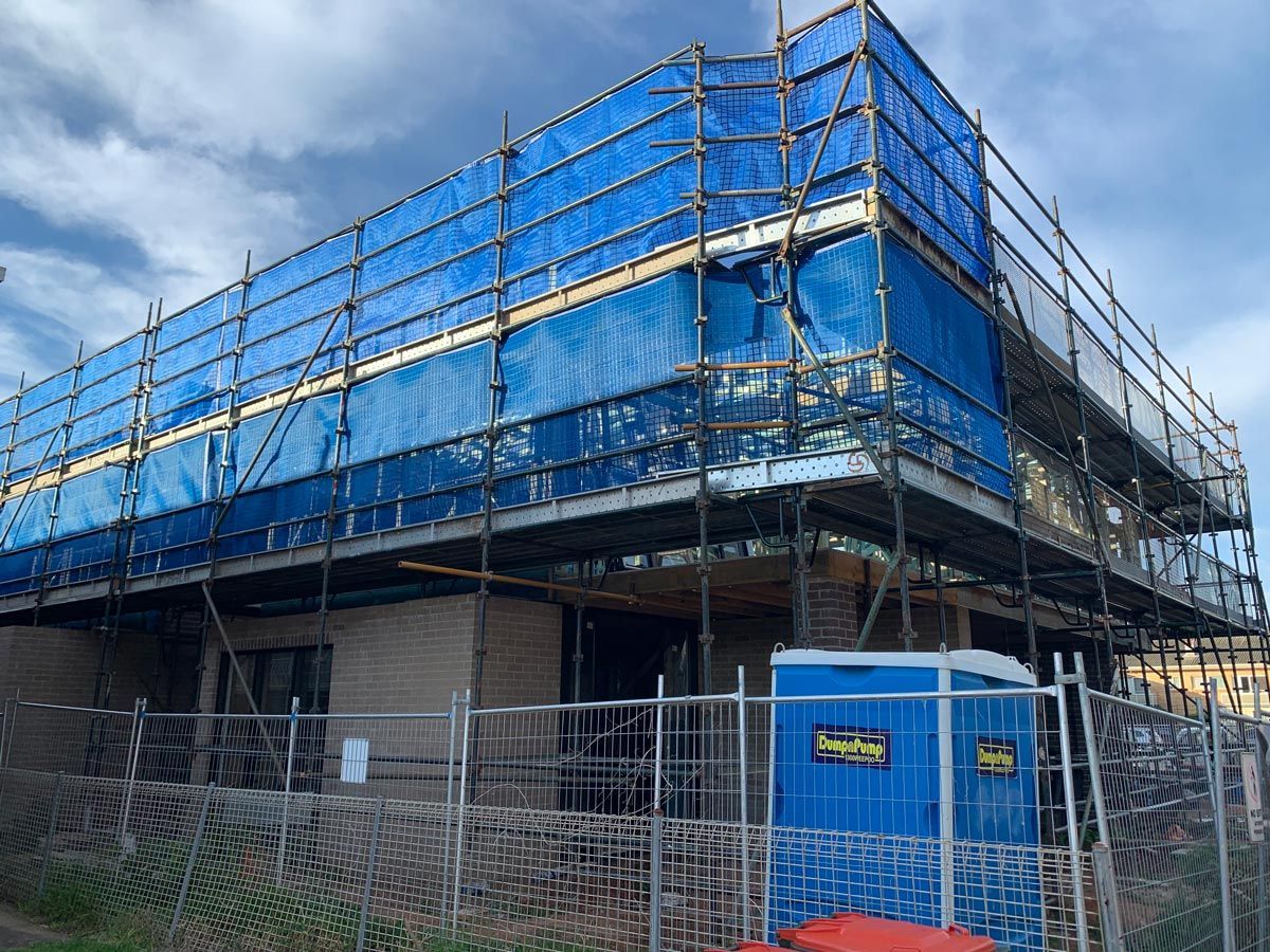 Building Under Construction, Scaffolded With Blue Safety Netting — NRS Scaffolding Pty Ltd in Laurieton, NSW