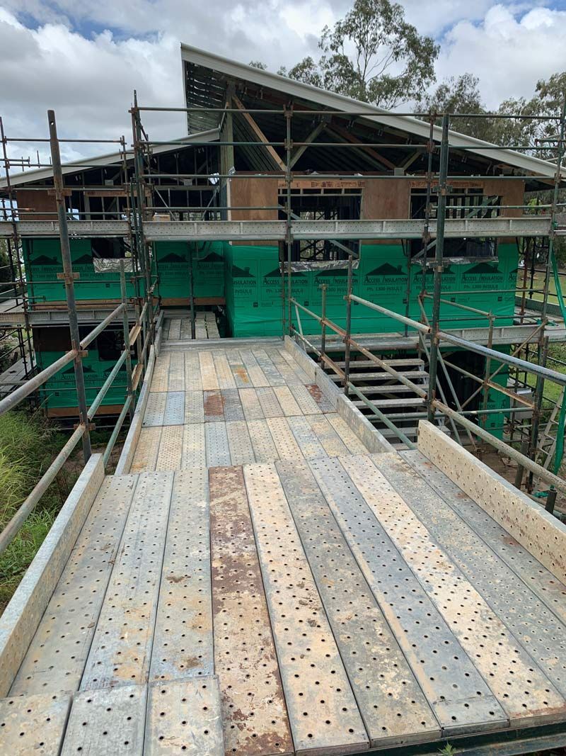 Construction Site: House Under Construction With Scaffolding, Bridge — NRS Scaffolding Pty Ltd in Taree, NSW