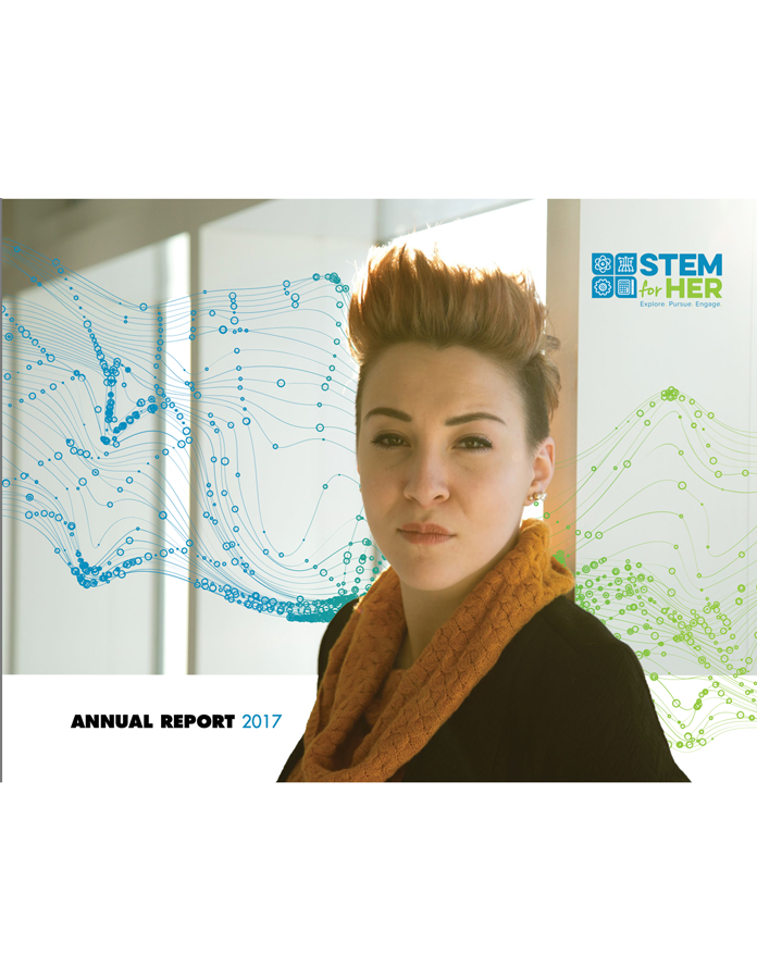 Woman in a black coat and orange scarf beside a STEM to HER annual report cover