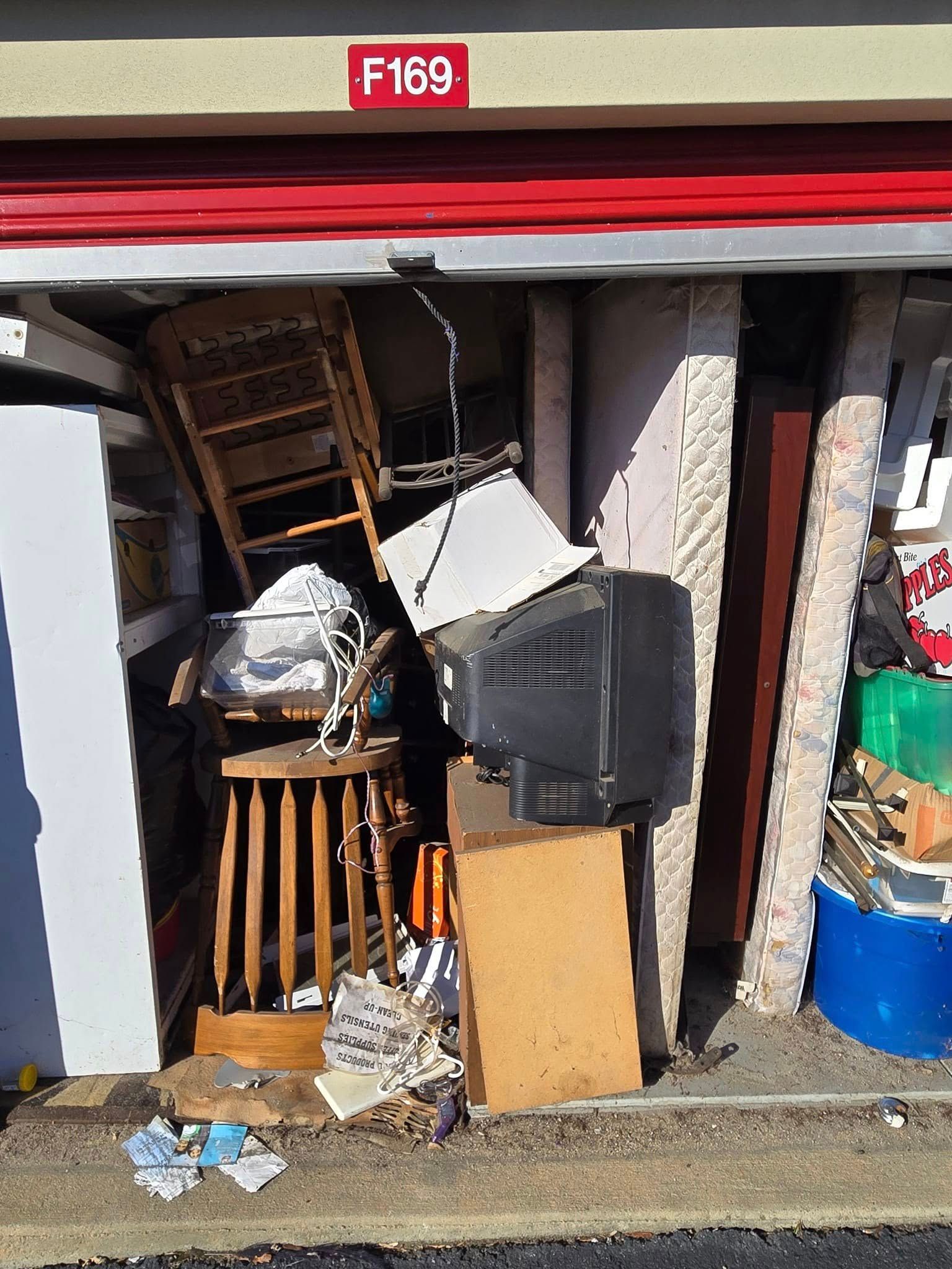 A messy garage with a red sign that says f169