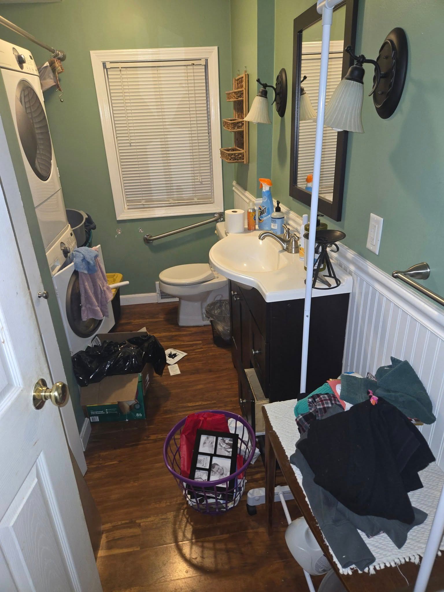 A bathroom with a sink , toilet and mirror.
