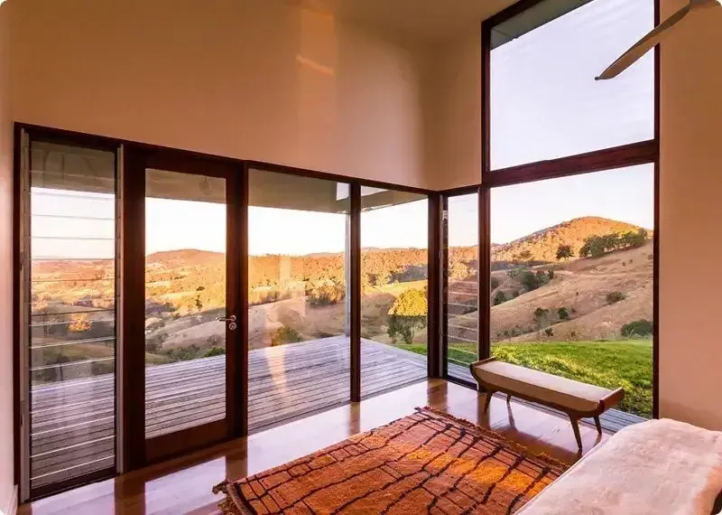 A living room with a view of a large deck in the background — Machin's Sawmill Pty Ltd In Wingham, NSW