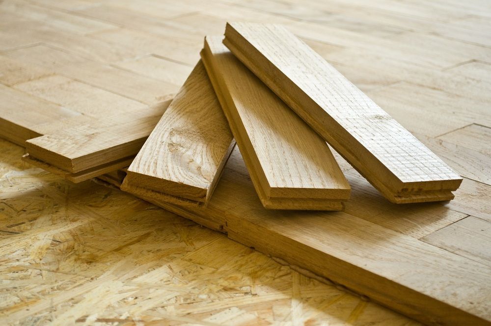 Four Pieces Of Wood Are Stacked On Top Of Each Other On A Wooden Floor — Machin's Sawmill Pty Ltd In Wingham, NSW