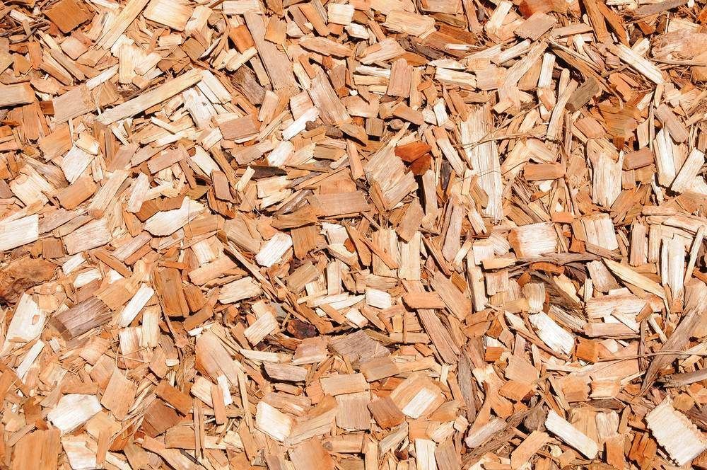 A Pile Of Wood Chips Is Sitting On The Ground — Machin's Sawmill Pty Ltd In Maitland, NSW