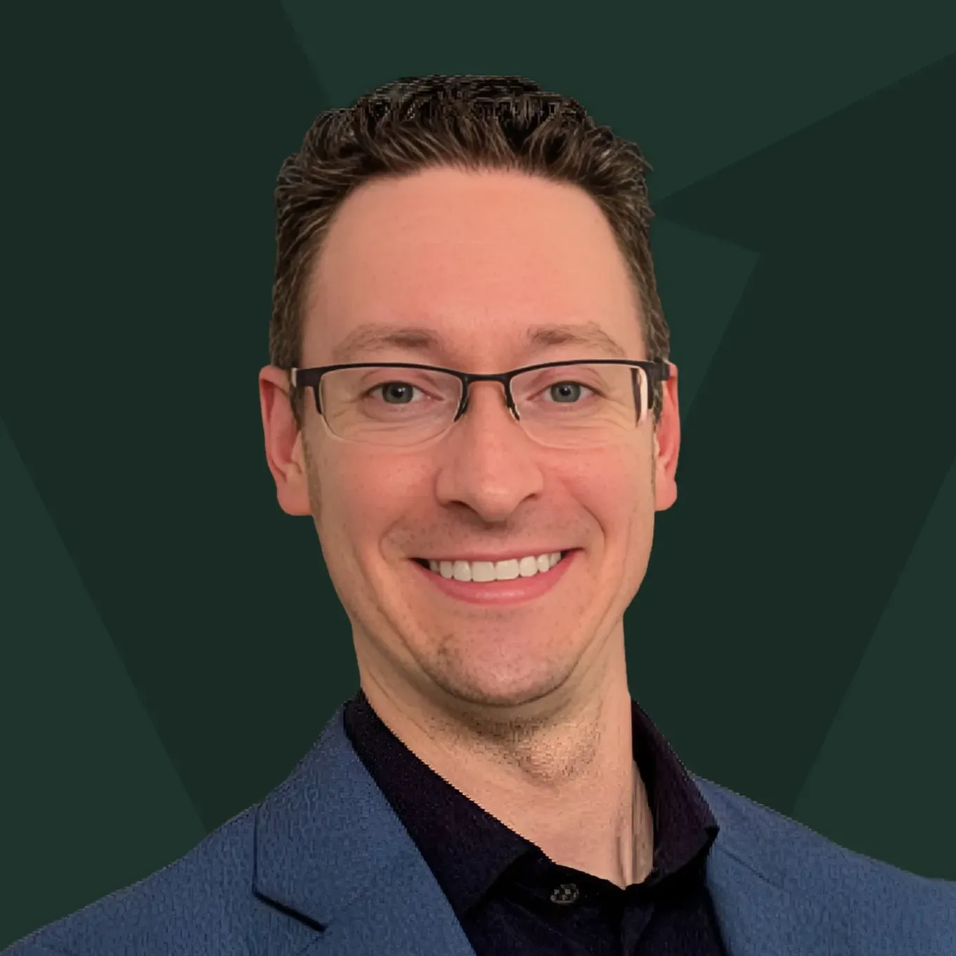 Smiling man in glasses and a blue blazer against a dark green geometric background