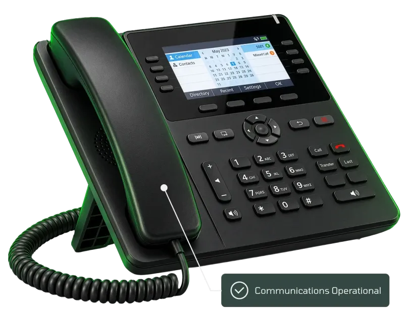 Black office desk phone with lit display, keypad, and handset on cradle