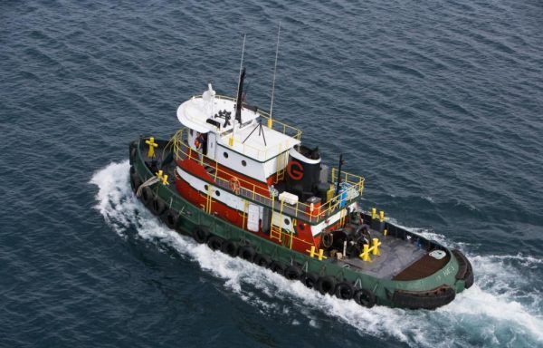 A large crane is sitting in the middle of a body of water