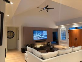 Interior with vaulted triangular ceiling and skylight above a beige wall and doorway.