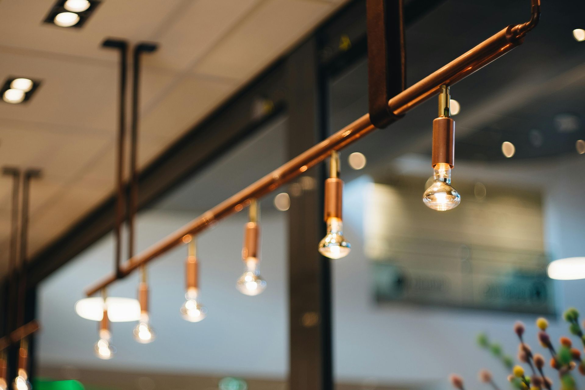 Row of hanging Edison-style pendant lights in a modern indoor space