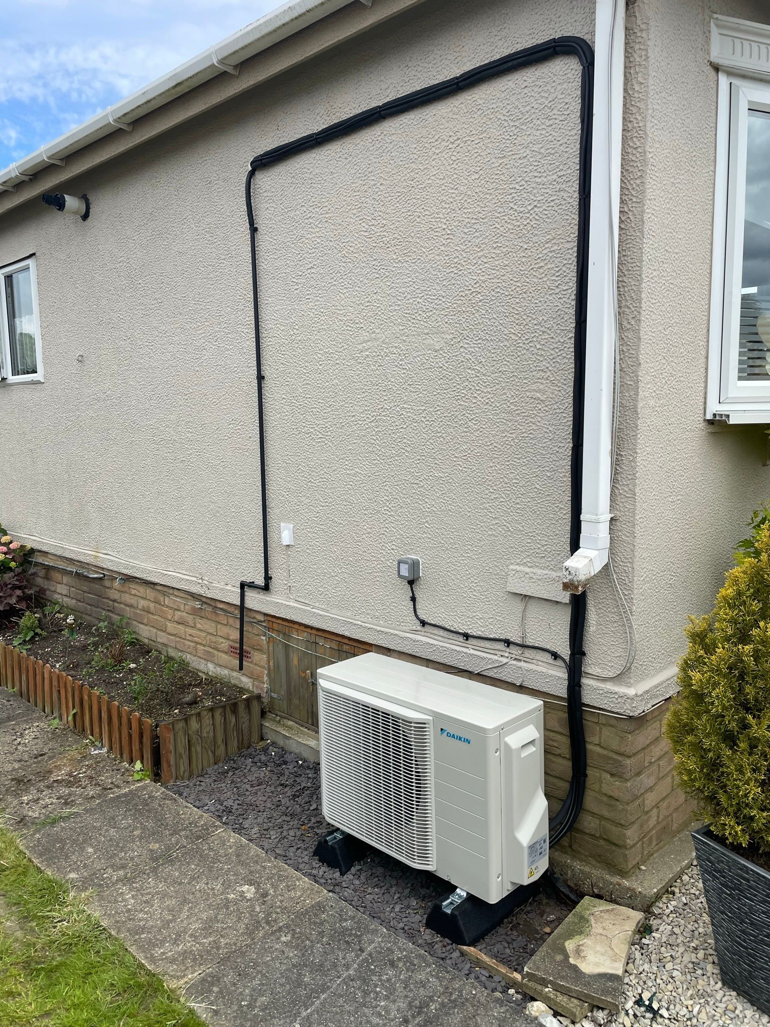 Neat finish on the services keeping tight to the down pipe