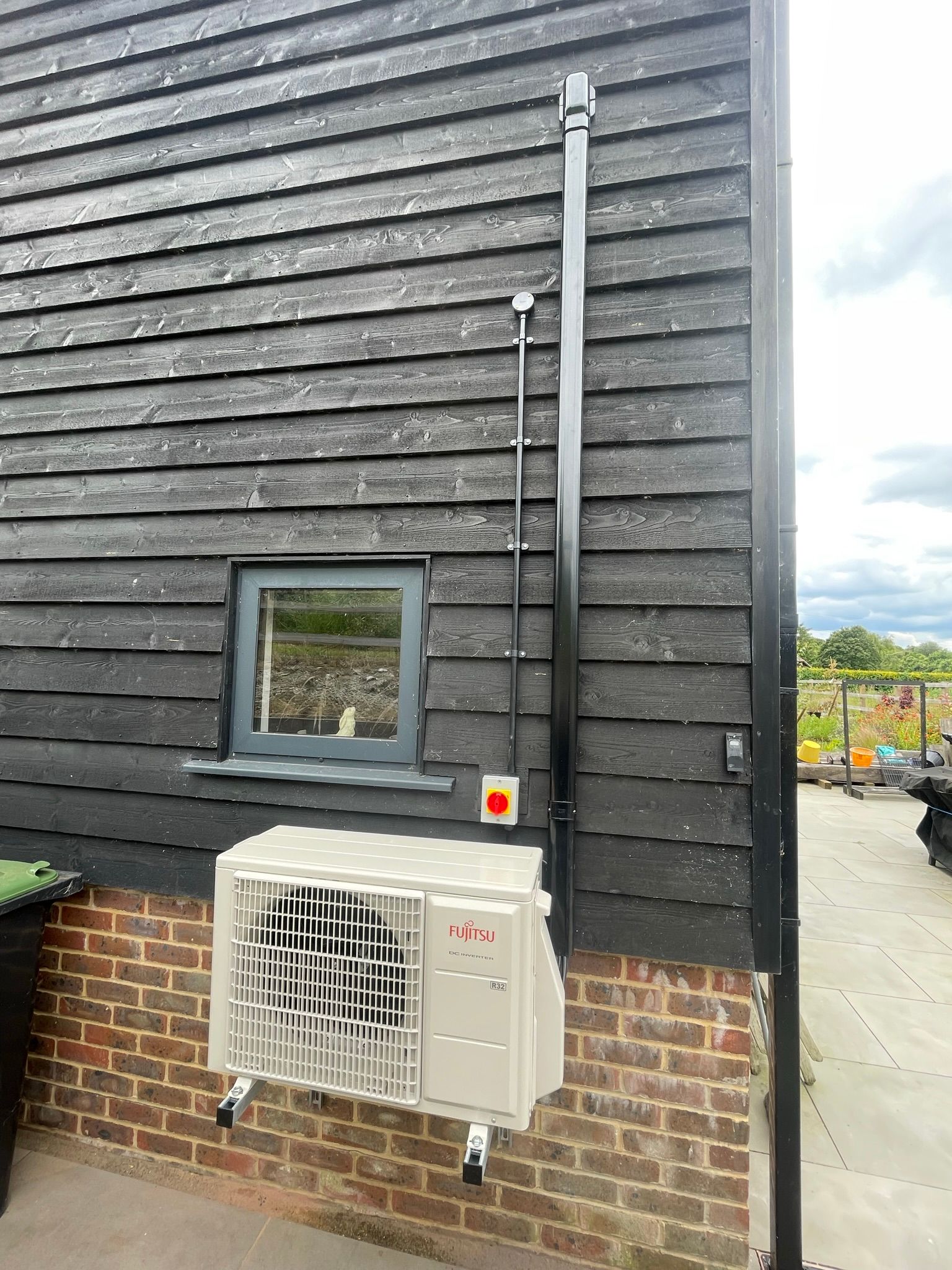 Services concealed within the trunking running down to the condenser.