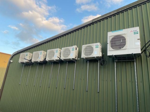 Commercial car dealership installation condensers neatly arranged at the same height